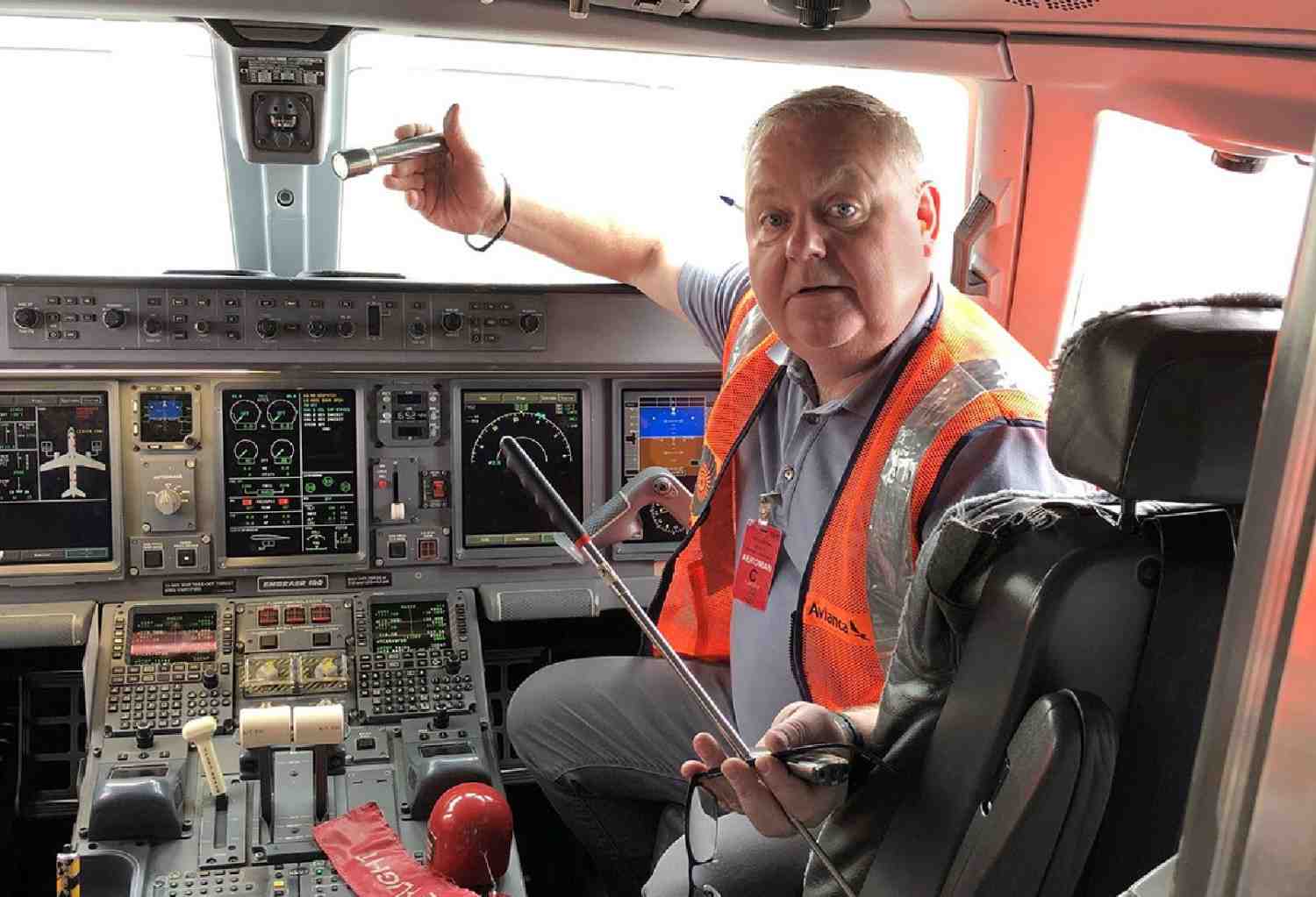 Person inspecting aircraft cockpit