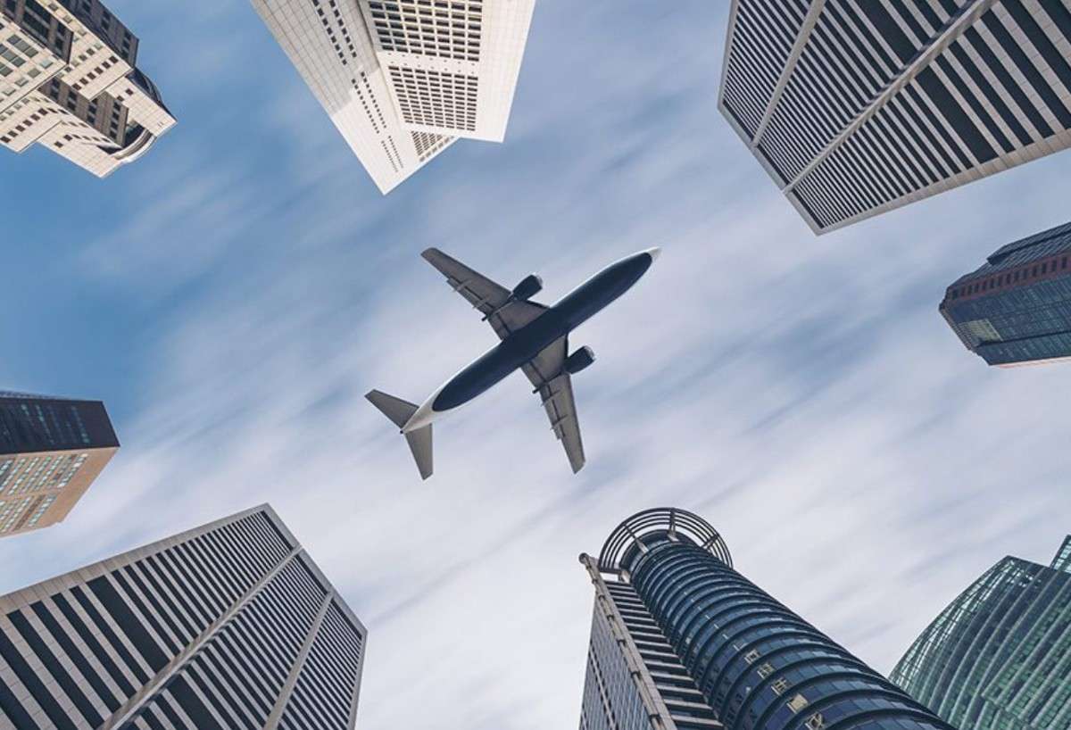 Plane above skyscrapers